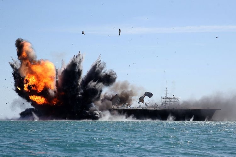 Garda Revolusi Iran menyerang kapal angkatan laut dalam latihan militer di Selat Hormuz, 25 Februari 2015. Ketegangan Amerika Serikat-Iran meningkat, seiring 10 kapal perang AS mengepung Iran pada akhir Januari 2026.(FARS/HAMED JAFARNEJAD via AFP)